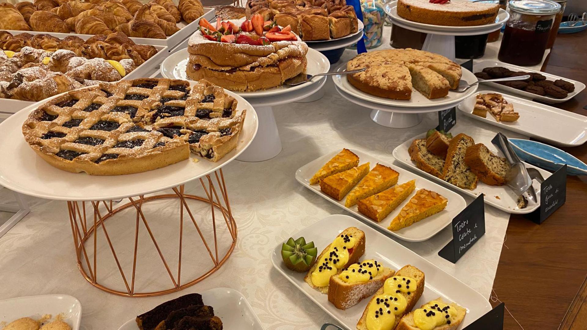 A dessert buffet with assorted cakes, pies, and pastries.